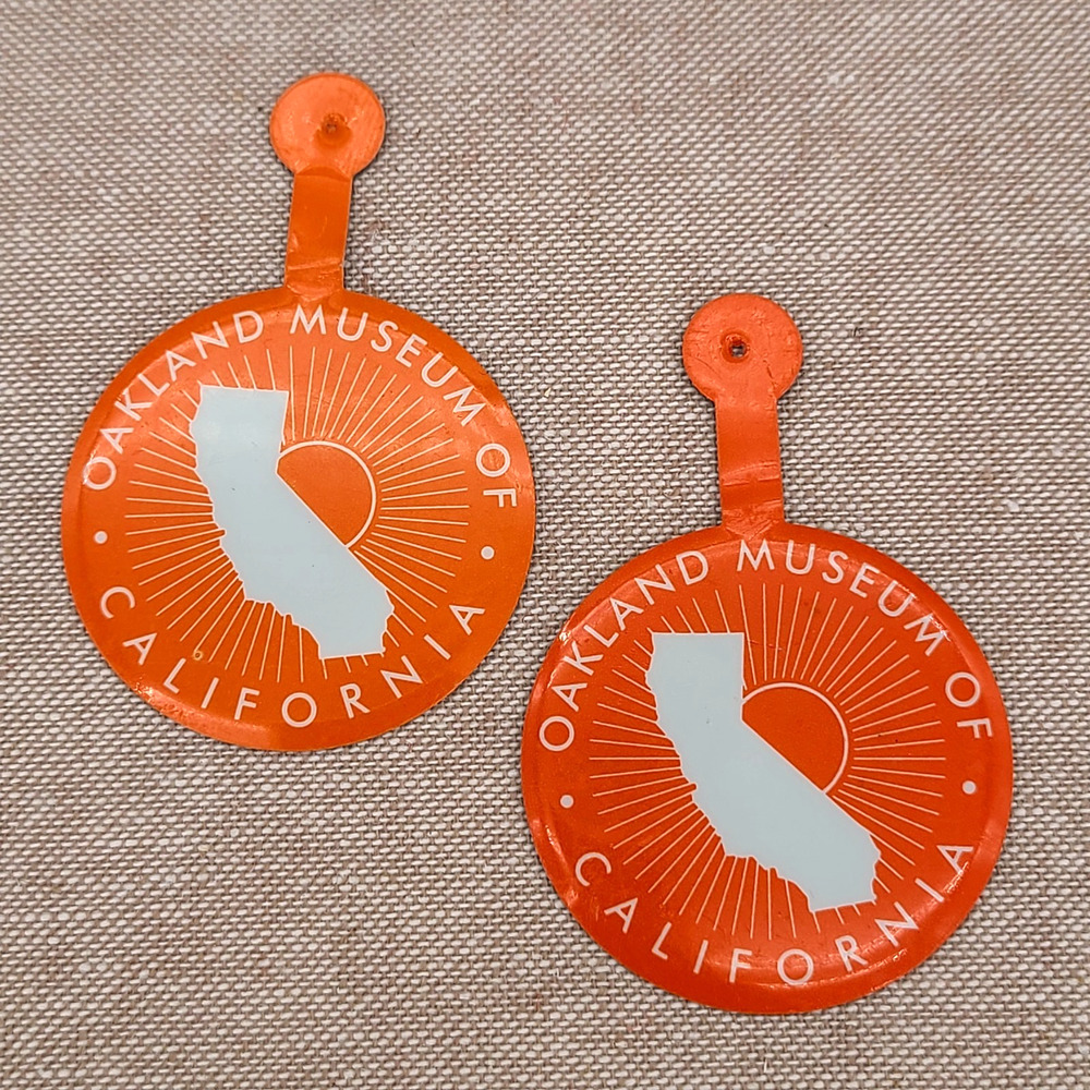 Lot of 2 San Francisco Oakland Museum of California Orange Bend Fold Tab Buttons